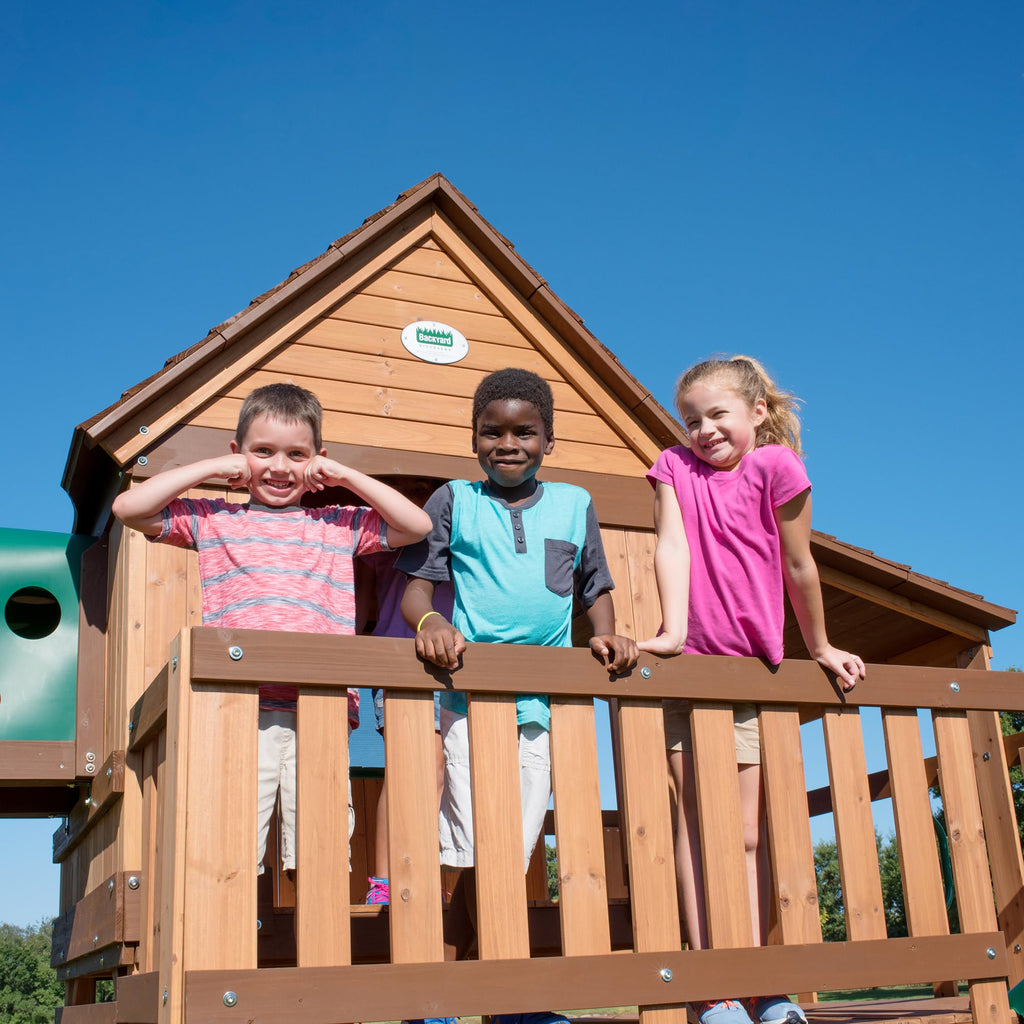 Backyard Discovery Woodridge Elite Cedar Wood Swing Set with Wave Slide, Clubhouse, Crawl Tunnel, Crow's Nest, Belt Swings, Trapeze, Rock Wall Ladder, Sandbox, Wrap-Around Porch, Deck, Outdoor Playset