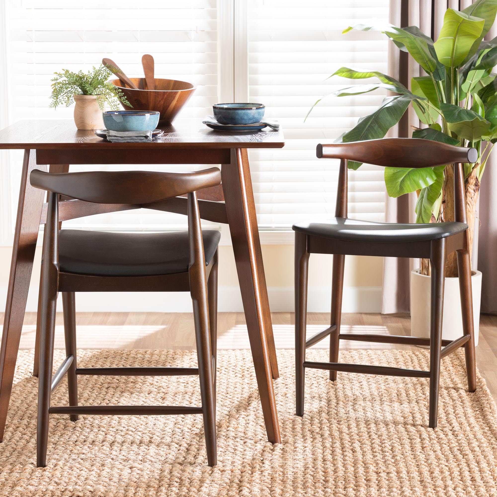Baxton Studio Eira Counter Stool Set of 2- Walnut Wood Frame Counter-Height Chair with Curved Backrest and Black Faux Leather Seat, Mid-Century Modern Kitchen Island Seating