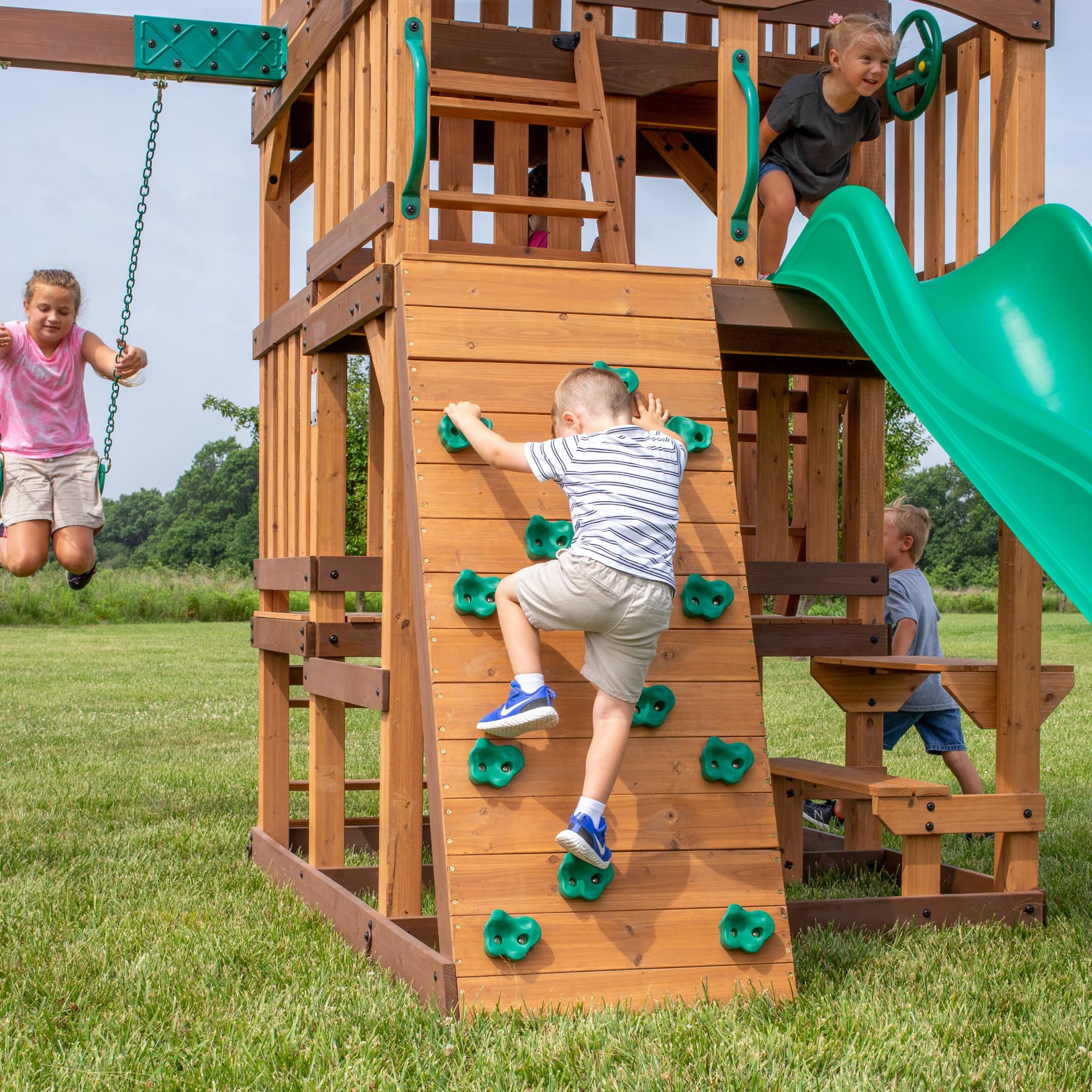Backyard Discovery Highlander Cedar Wood Swing Set with Wave Slide, Three-Story Clubhouse, Rock Wall, Picnic Table, Belt Swings, Web Swing, Sandbox, Three Ladders, Toy Accessories, Outdoor Playset