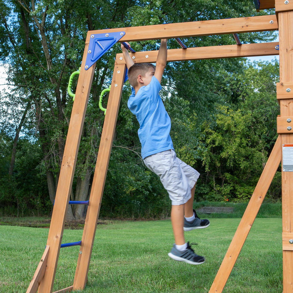 Backyard Discovery Beach Front Cedar Wood Swing Set with Wave Slide, Play Deck, Monkey Bars, Rock Wall Ladder, Shaded Picnic Area, Snack Bar, Belt Swings, Trapeze, Sandbox Area, Outdoor Playset