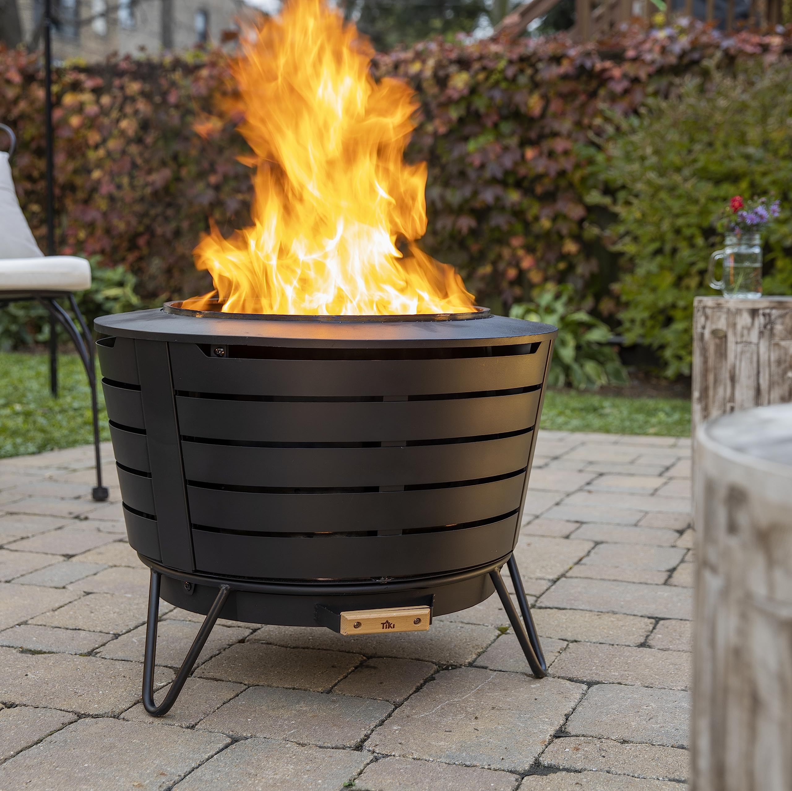 TIKI Patio Smokeless Outdoor Fire Pit, 25-Inch Wood-Burning Bonfire with Removable Ash Pan, Stand, and Weather-Resistant Cover