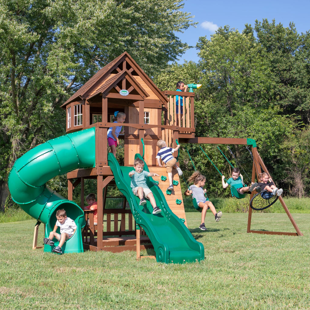 Backyard Discovery Skyfort All Cedar Swing Set, Elevated Covered Wood Roof Clubhouse with Bay Windows, 2 Belt Swings, Web Swing, 10ft Wave Slide, 5 ft Tube Slide, Covered Picnic Table, 5 ft Rock Wall